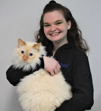 Autumn holding a fluffy cat with blue eyes